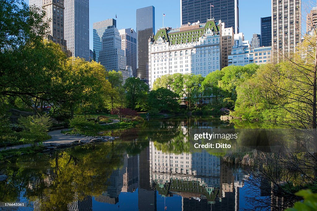 Buildings on lake in Central Park, New York City, USA