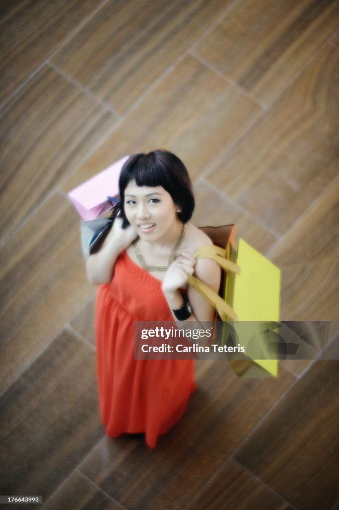 Woman in a red dress with shopping bags