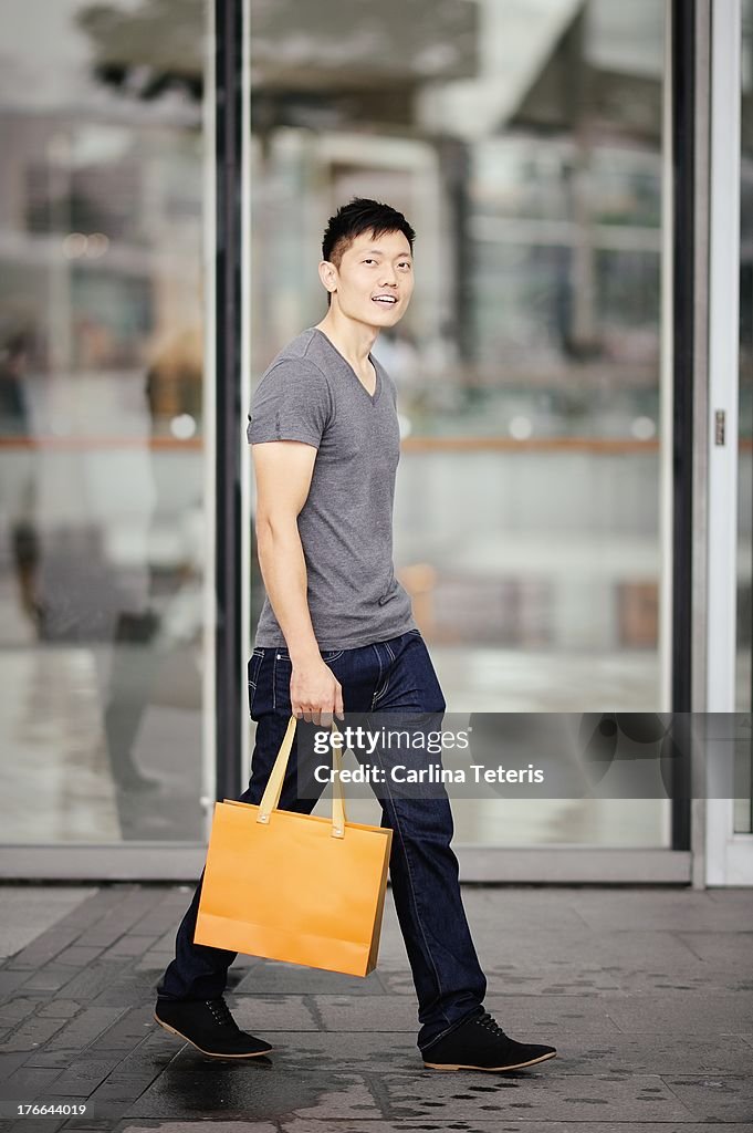 A Man walks in front of a mall