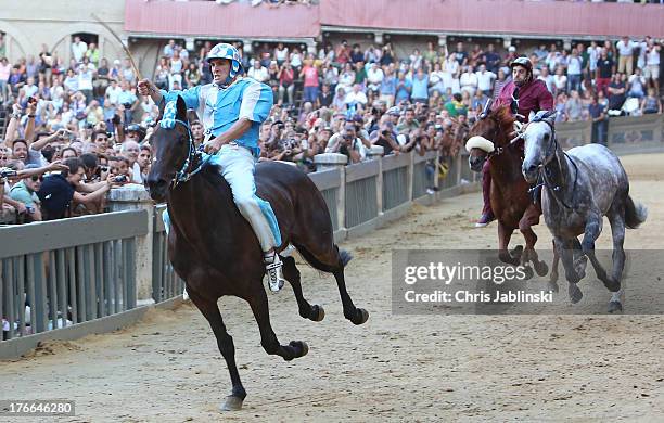 Giovanni Atzeni , known as Tittia, rides his horse bareback on his way to winning the Palio dell'Assunta horse-race at Piazza del Campo square on...