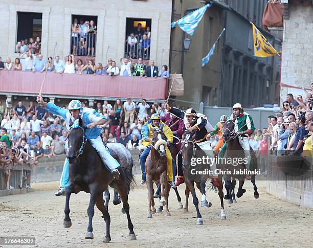 Jockey Giovanni Atzeni , known as Tittia, rides his horse bareback on his way to winning the Palio dell'Assunta horse-race at Piazza del Campo square...