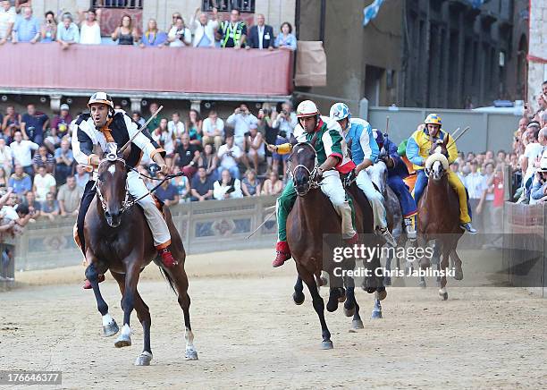 Competitors race riding bareback during the annual Palio dell'Assunta horse-race at the Piazza del Campo Square on August 16, 2013 in Siena, Italy....