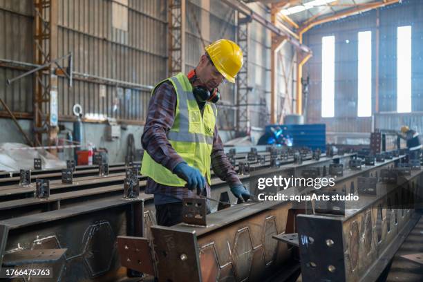 industrial worker in a factory - metal material stock pictures, royalty-free photos & images