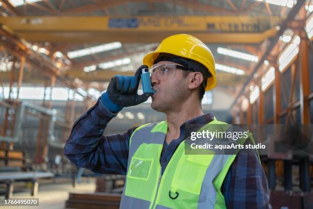 industrial worker with asthma inhaler - asthma attack work stock pictures, royalty-free photos & images