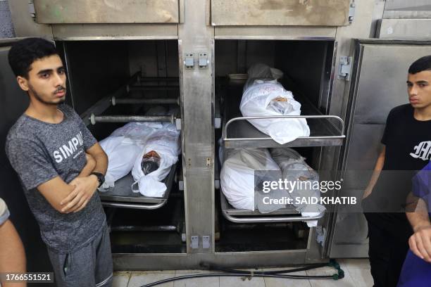 The bodies of members of the same Palestinian family killed in Israeli bombardment, are placed in the morgue of the al-Najar hospital, prior to their...