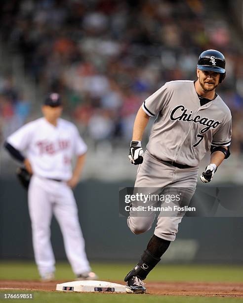 Trevor Plouffe of the Minnesota Twins looks on as Jeff Keppinger of the Chicago White Sox rounds third base after hitting a solo home run during the...