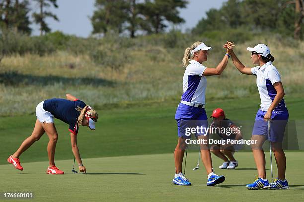 Suzann Pettersen of Norway and Carlota Ciganda of Spain and the European Team celebrate on the 10th green as they went on to defeat Stacy Lewis and...