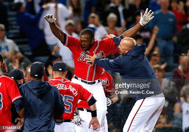 Justin Upton of the Atlanta Braves celebrates after hitting a solo walk-off homer in the 10th inning against the Washington Nationals at Turner Field...