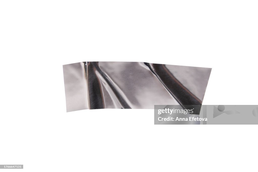 Festive silver metallic wrinkled adhesive tape. Festive design element for multiple types of graphic design decorations. Isolated on white background, cut out. Textured, high resolution