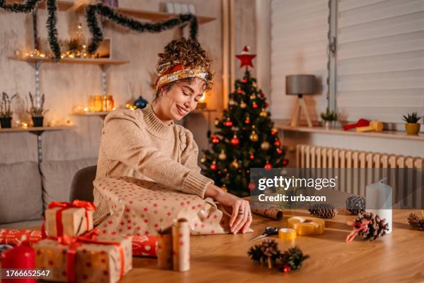junge frau verpackung weihnachten geschenke wie zu hause fühlen. - einwickeln stock-fotos und bilder