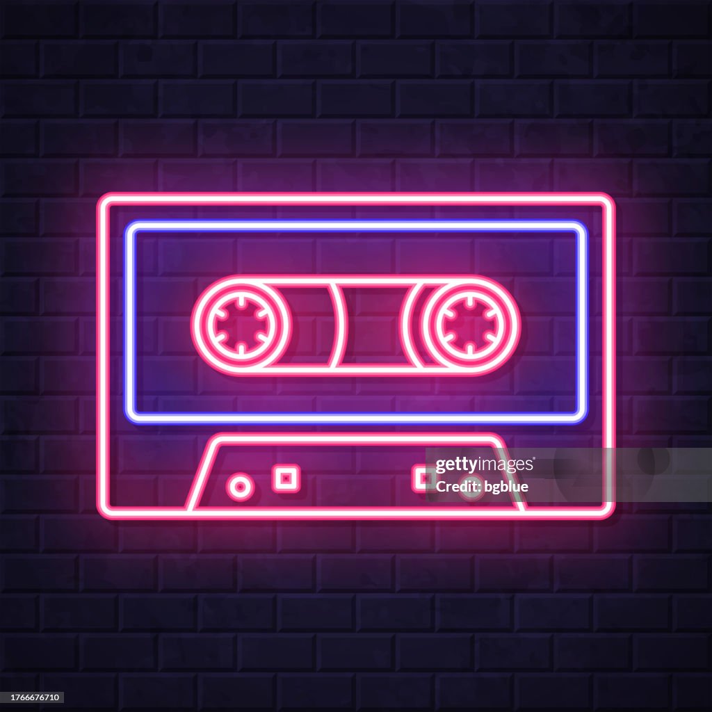 Cassette tape. Glowing neon icon on brick wall background