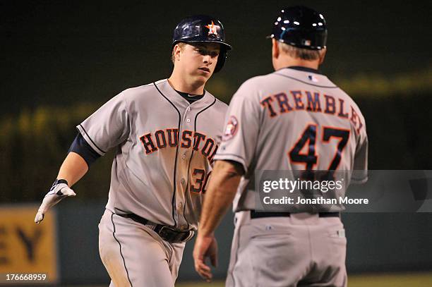 Matt Dominguez of the Houston Astros celebrates with Third Base Coach Dave Trembley after hitting a home run in the eighth inning during a game...