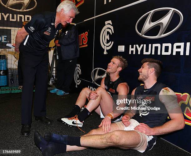 Blues Coach Michael Malthouse speaks to Nick Graham and Bryce Gibbs after the win during the round 21 AFL match between the Richmond Tigers and the...