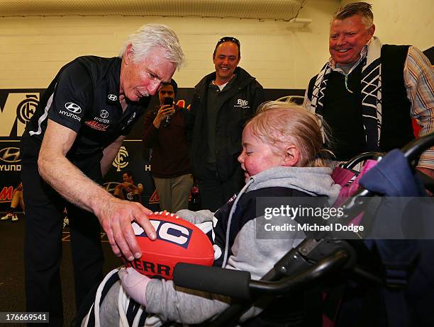 Blues Coach Michael Malthouse celebrates the win with a fan during the round 21 AFL match between the Richmond Tigers and the Carlton Blues at...