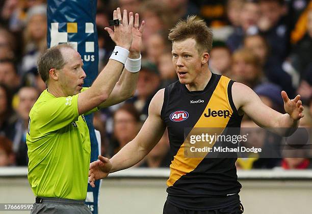 Jack Riewoldt of the Tigers reacts after umpire Stephen McBurney makes a decision during the round 21 AFL match between the Richmond Tigers and the...