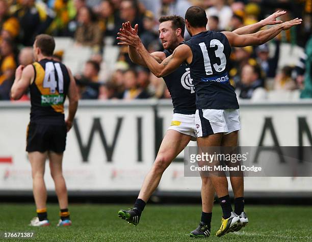 Brock McLean and Eddie Betts of the Blues celebrate a goal during the round 21 AFL match between the Richmond Tigers and the Carlton Blues at...