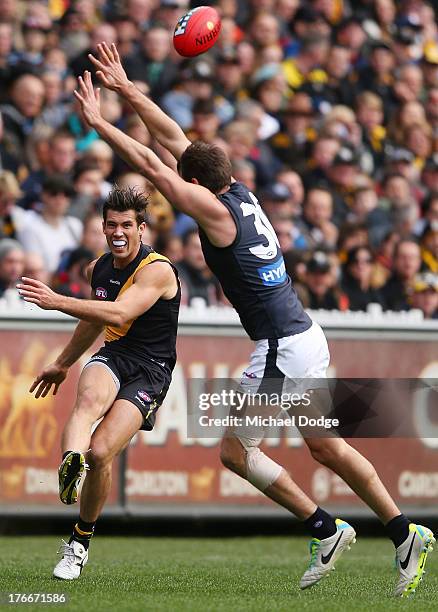 Alex Rance kicks the ball past Jarrad Waite of the Blues during the round 21 AFL match between the Richmond Tigers and the Carlton Blues at Melbourne...