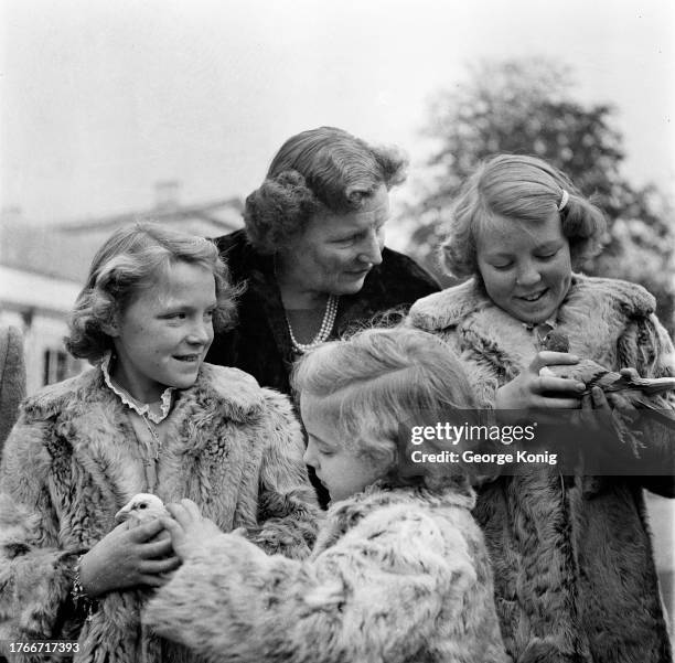 Queen Juliana of the Netherlands with daughters Princess Irene, Princess Margriet and Princess Beatrix in the grounds of Soestdijk Palace in Baarn,...