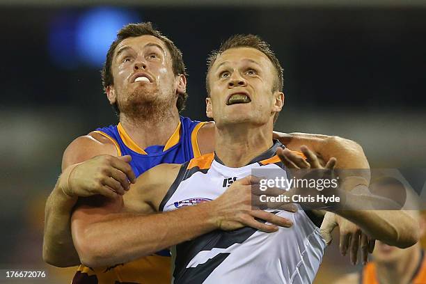 Matthew Leuenberger of the Lions and Dean Brogan of the Giants compete for the ball during the round 21 AFL match between the Brisbane Lions and the...