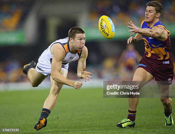 Toby Greene of the Giants handballs during the round 21 AFL match between the Brisbane Lions and the Greater Western Sydney Giants at The Gabba on...