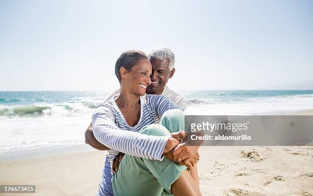 affectionate senior couple - older couple hugging on beach stock pictures, royalty-free photos & images