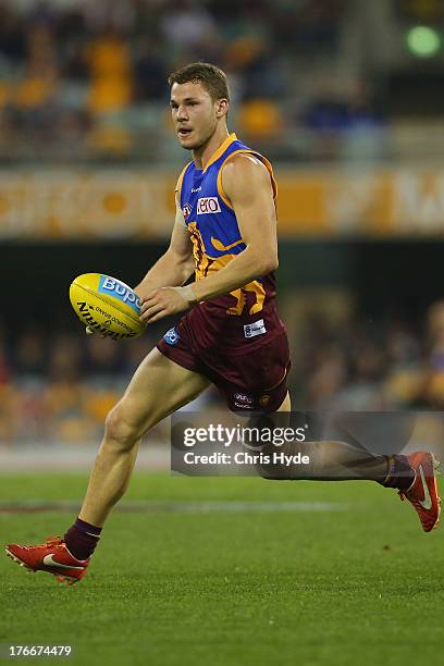 Jack Redden of the Lions runs the ball during the round 21 AFL match between the Brisbane Lions and the Greater Western Sydney Giants at The Gabba on...