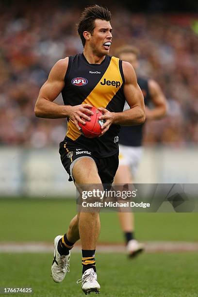 Alex Rance of the Tigers runs with the ball during the round 21 AFL match between the Richmond Tigers and the Carlton Blues at Melbourne Cricket...