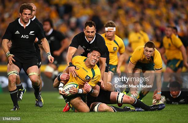 Israel Dagg of the All Blacks tackles Christian Leali'ifano of the Wallabies during The Rugby Championship Bledisloe Cup match between the Australian...