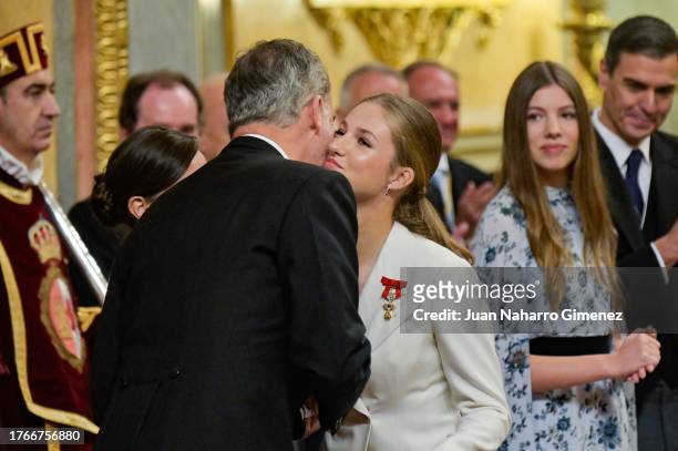 King Felipe VI of Spain congratulates Crown Princess Leonor after swearing allegiance to the Spanish constitution at the Spanish Parliament on the...