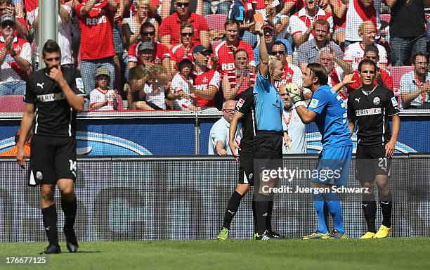 Tim Kister of Sandhausen leaves the pitch after he is shown the red card by referee Bibiana Steinhaus whilst goalkeeper Manuel Riemann of Sandhausen...