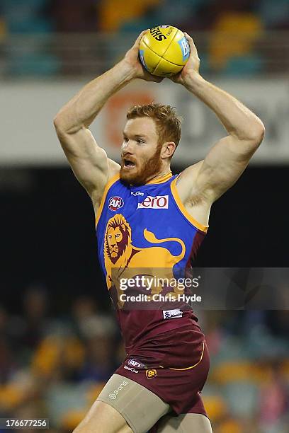 Daniel Merrett of the Lions takes a mark during the round 21 AFL match between the Brisbane Lions and the Greater Western Sydney Giants at The Gabba...