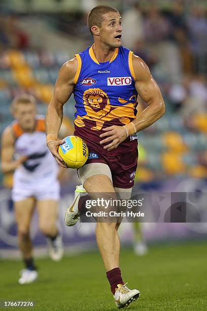 Matt Maguire of the Lions runs the ball during the round 21 AFL match between the Brisbane Lions and the Greater Western Sydney Giants at The Gabba...