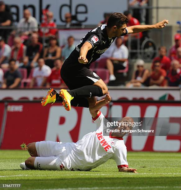 Matthias Zimmermann of Sandhausen jumps over Maurice Exslager of Cologne during the Second Bundesliga match between 1. FC Koeln and SV Sandhausen on...