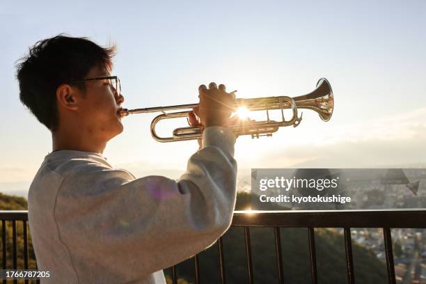 Teenage Boy Playing Trumpet Side View High-Res Stock Photo - Getty Images