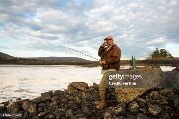 a sport fisher at dusk on a river estuary - surf casting stock pictures, royalty-free photos & images