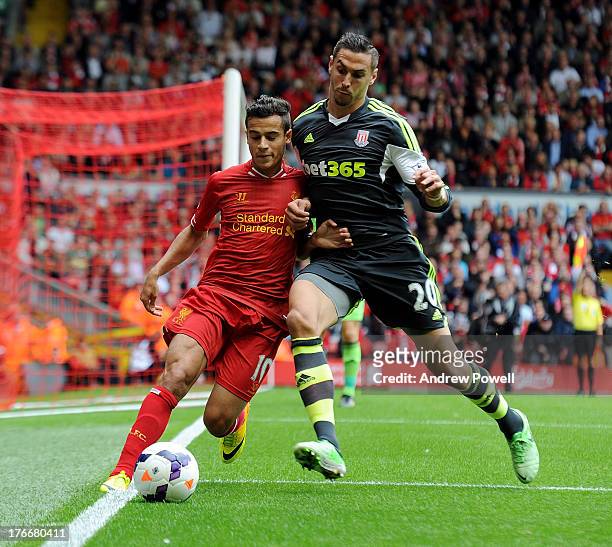 Philippe Coutinho of Liverpool and Geoff Cameron of Stoke City compete during the Barclays Premier League match between Liverpool and Stoke City at...