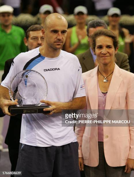 Croatia's Ivan Ljubicic holds his runners up trophy as he poses with Spain's Princess Elena after the Men's singles final at the Madrid masters...