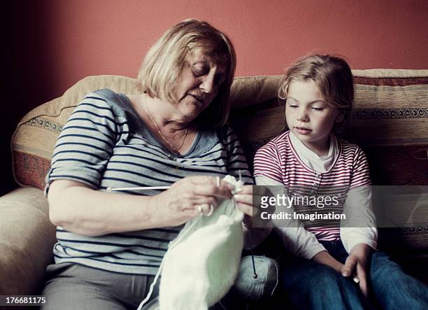 grandmother teaching granddaughter to knit - irish family stock pictures, royalty-free photos & images