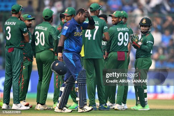 Sri Lanka's Angelo Mathews walks back to the pavilion after he was timed out during the 2023 ICC Men's Cricket World Cup one-day international match...