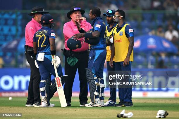 Sri Lanka's Angelo Mathews speaks with the umpires after he was timed out during the 2023 ICC Men's Cricket World Cup one-day international match...