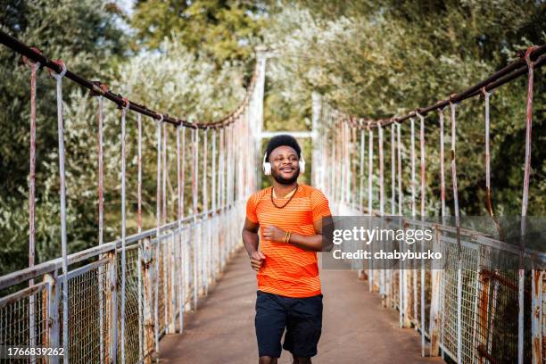 african american man running on the bridge - eastern european stock pictures, royalty-free photos & images