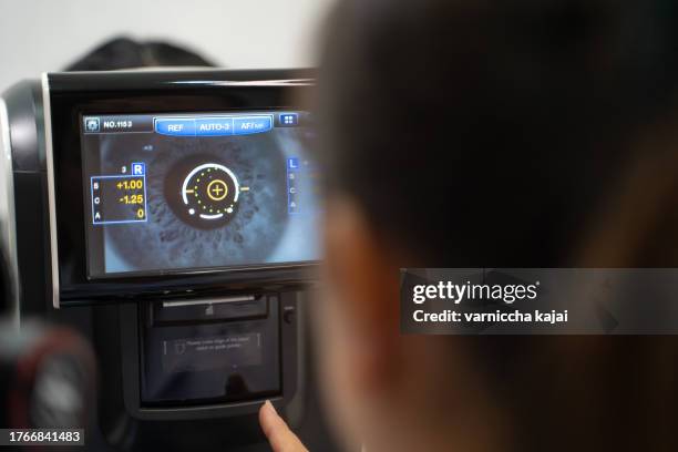 doctor and female patient in ophthalmology clinic check your eyesight with modern equipment. - cornea stock pictures, royalty-free photos & images