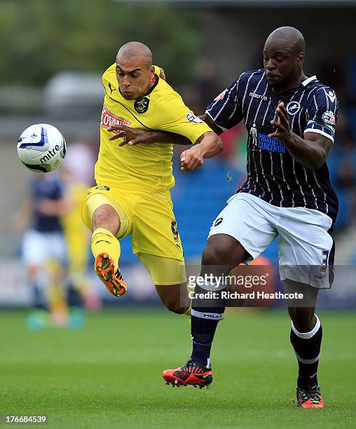 James Vaughan of Huddesfield holds off Danny Shittu of Millwall during the Sky Bet Championship match between Millwall and Huddersfield Town at The...