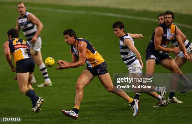 Andrew Embley of the Eagles handballs during the round 21 AFL match between the West Coast Eagles and the Geelong Cats at Patersons Stadium on August...