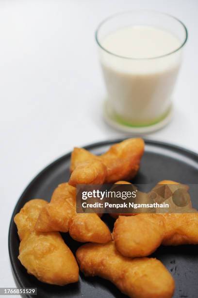 soybean milk soy in glass cup and deep-fried doughstick - youtiao stock pictures, royalty-free photos & images