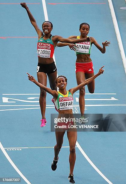 Winner Ethiopia's Meseret Defar , Kenya's Mercy Cherono and third placed Ethiopia's Almaz Ayana cross the finish line during the women's 5000 metres...