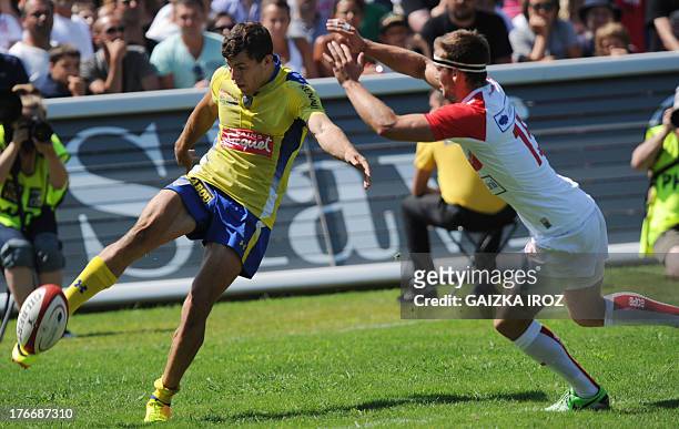 Clermont's full-back Jean-Marcelin Buttin kicks the ball past Biarritz's full-back Paul Couet-Lannes during the French Top 14 rugby union match...