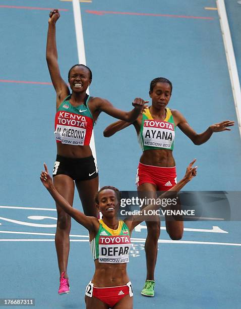 Winner Ethiopia's Meseret Defar , Kenya's Mercy Cherono and third placed Ethiopia's Almaz Ayana cross the finish line during the women's 5000 metres...