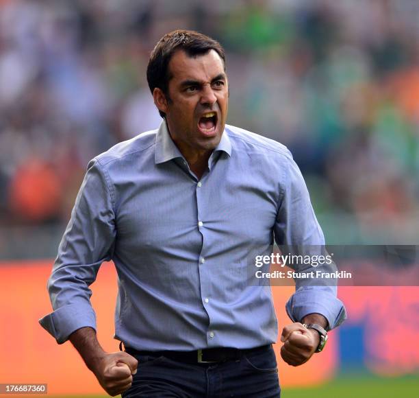 Robin Dutt, head coach of Bremen celebrates his first home win as head coach during the Bundesliga match between Werder Bremen and FC Augsburg at...