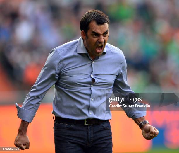 Robin Dutt, head coach of Bremen celebrates his first home win as head coach during the Bundesliga match between Werder Bremen and FC Augsburg at...